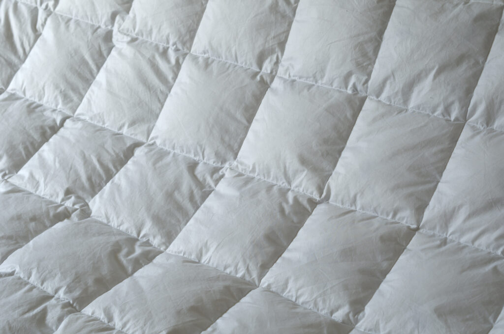 Detail of down comforter with white squares
