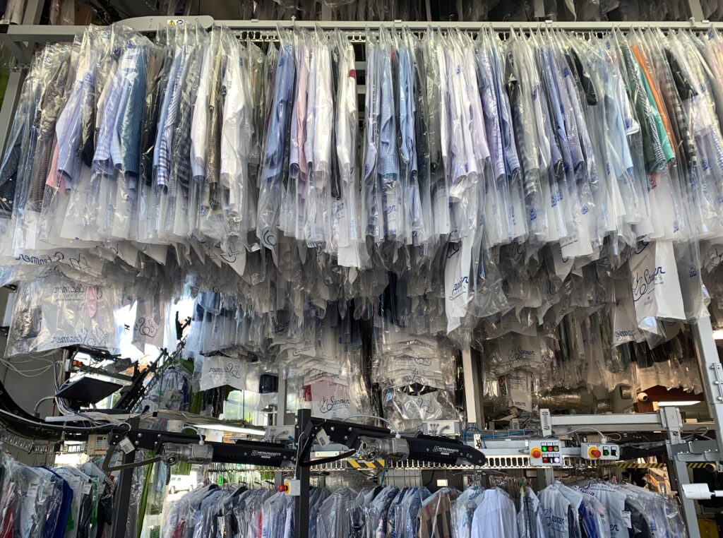 rows-and-rows-of-clothes-in-plastic-on-the-conveyo-2025-01-08-17-33-51-utc